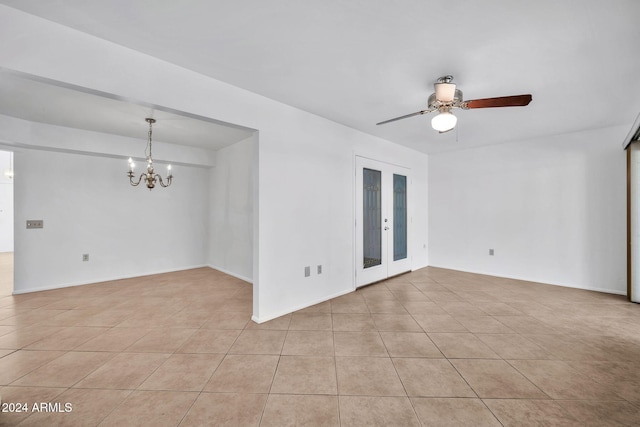 unfurnished room with light tile patterned flooring and ceiling fan with notable chandelier