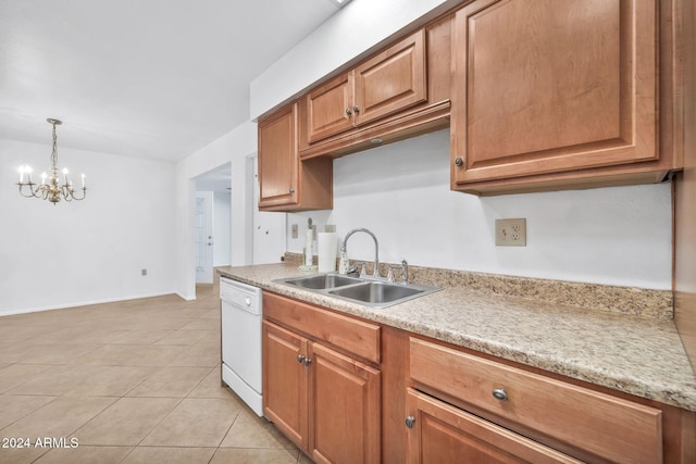 kitchen with sink, white dishwasher, pendant lighting, light tile patterned floors, and an inviting chandelier