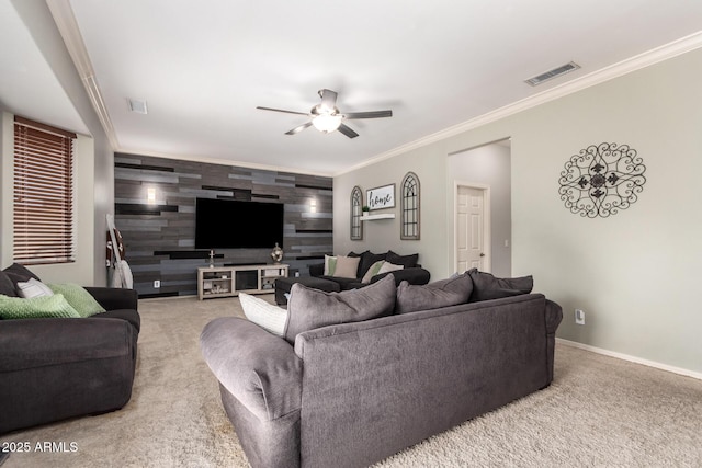 living room with wooden walls, light colored carpet, ceiling fan, and ornamental molding