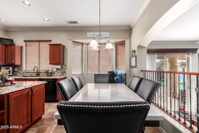 dining space with sink and crown molding