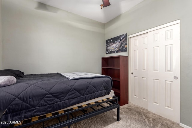 bedroom with ceiling fan, carpet, and a closet