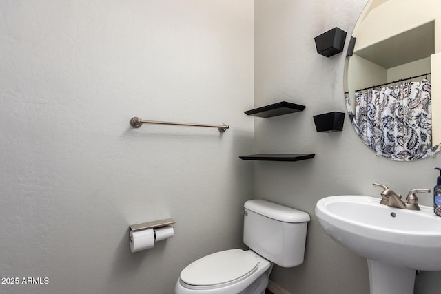 bathroom featuring sink and toilet