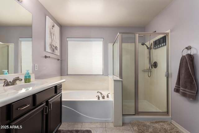 bathroom featuring tile patterned flooring, shower with separate bathtub, and vanity