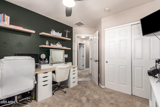 carpeted office with ceiling fan