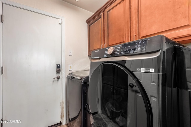 laundry room with cabinets and separate washer and dryer