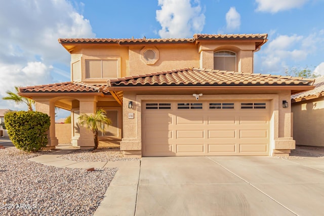 mediterranean / spanish-style house with a garage