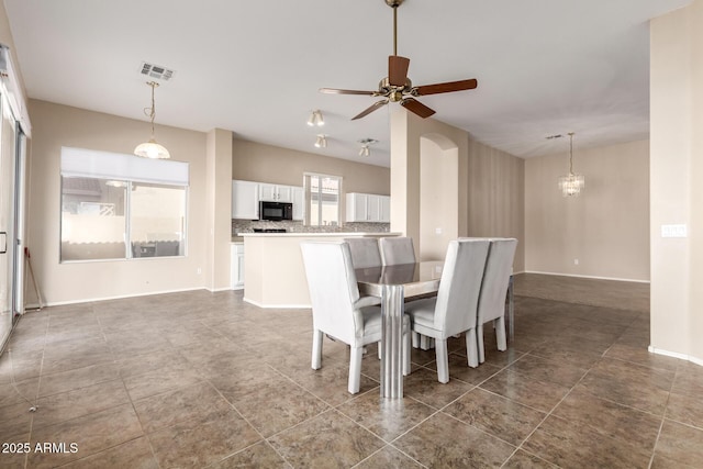 dining area with visible vents, baseboards, and a ceiling fan