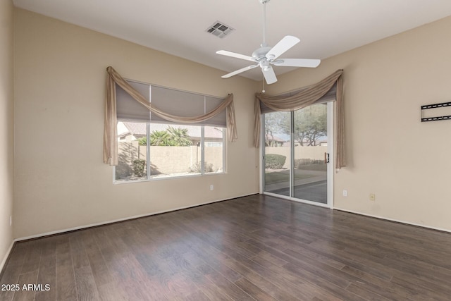 spare room featuring visible vents, a ceiling fan, and wood finished floors