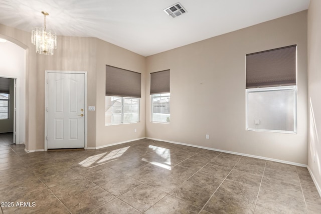 entryway featuring tile patterned flooring, visible vents, baseboards, an inviting chandelier, and arched walkways