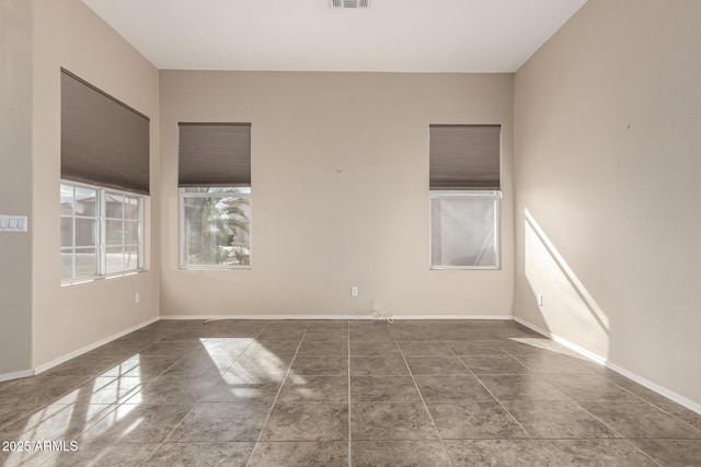 spare room featuring visible vents and baseboards