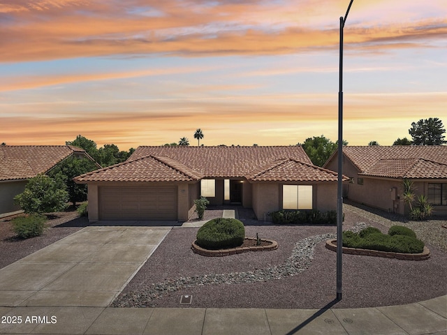 9263 W Oraibi Dr, Peoria, AZ 85382 - view of front facade with an attached garage, stucco siding, and a tile roof