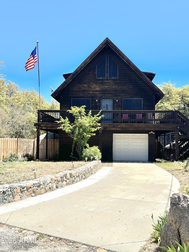 16947 W Willow Ave, Yarnell, AZ 85362 - rustic home with a wooden deck, fence, stairs, an attached garage, and driveway
