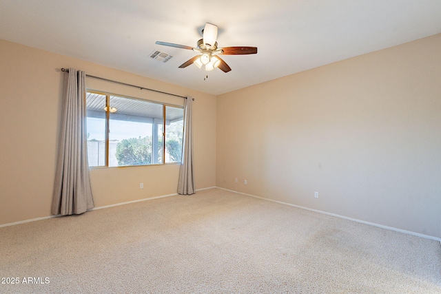 empty room featuring light carpet and ceiling fan