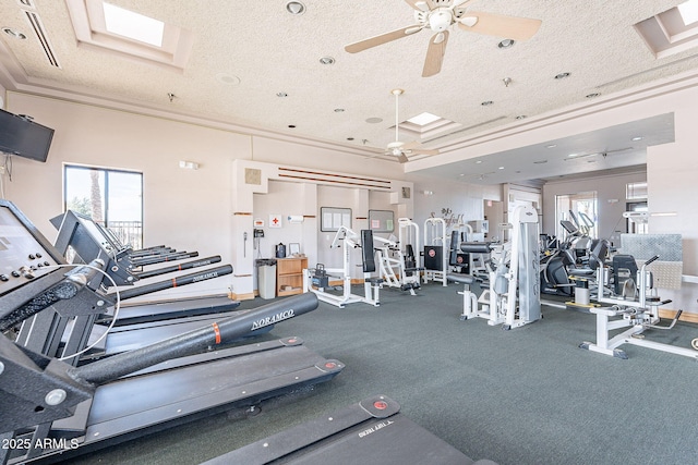 gym featuring ceiling fan, crown molding, and a textured ceiling