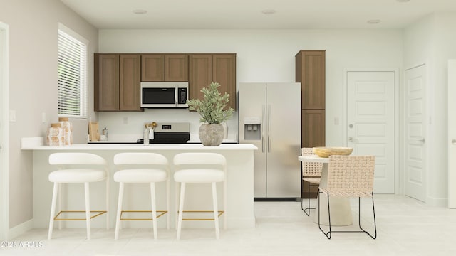 23073 E Saddle Way, Queen Creek, AZ 85142 - kitchen featuring refrigerator with ice dispenser, stainless steel microwave, a kitchen breakfast bar, and a peninsula