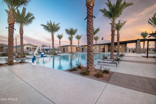 23073 E Saddle Way, Queen Creek, AZ 85142 - pool at dusk featuring a community pool and a patio area