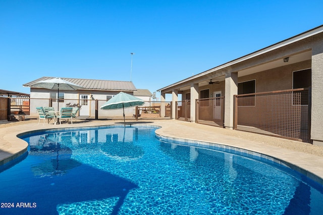 view of pool featuring ceiling fan and a patio area