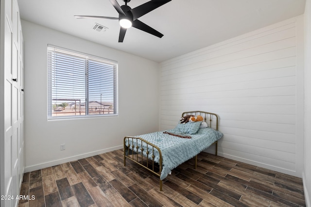 bedroom with ceiling fan and dark hardwood / wood-style floors