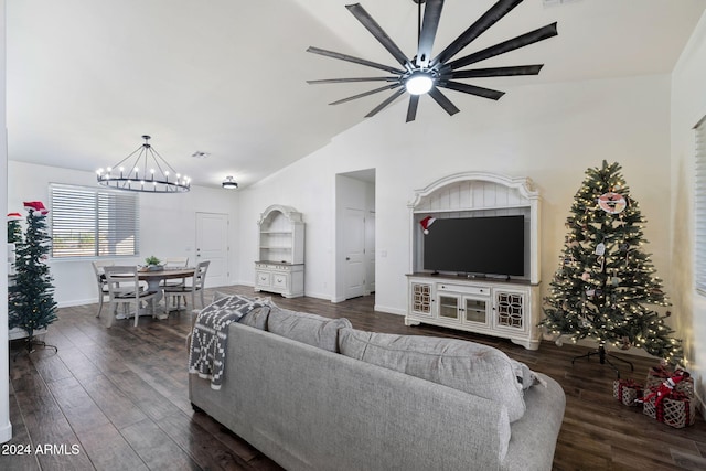 living room with ceiling fan with notable chandelier, dark hardwood / wood-style flooring, and lofted ceiling