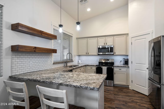 kitchen featuring sink, kitchen peninsula, stainless steel appliances, and high vaulted ceiling