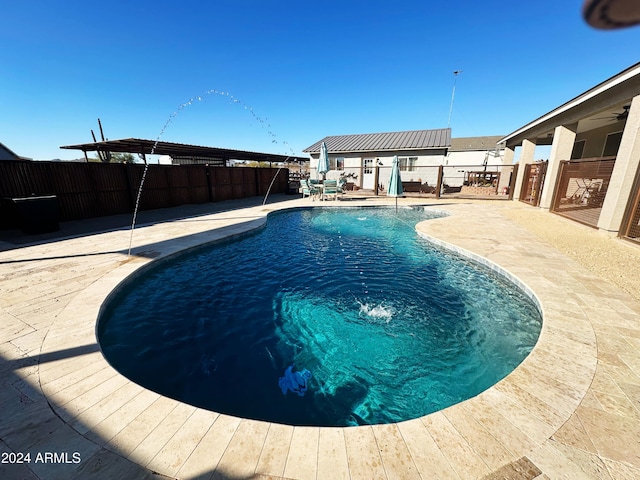 view of swimming pool featuring a patio area and pool water feature