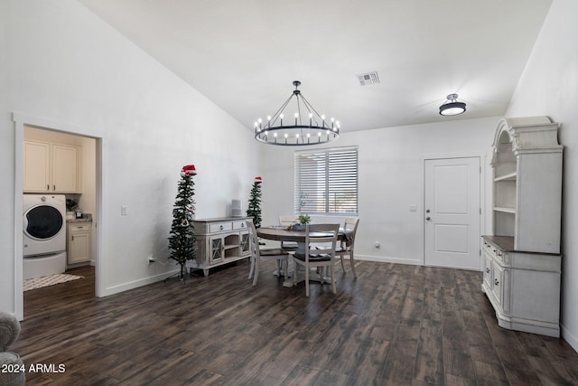 dining space featuring dark hardwood / wood-style flooring, washer / dryer, lofted ceiling, and a chandelier