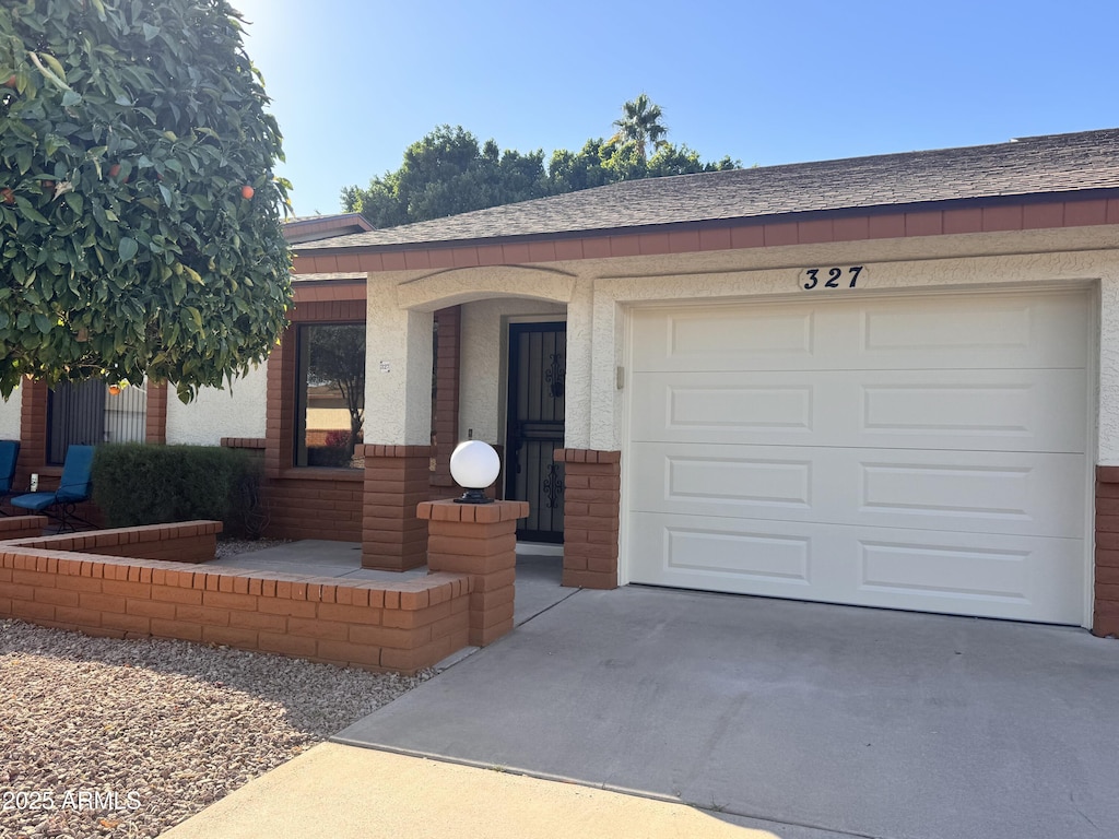 ranch-style house featuring a garage