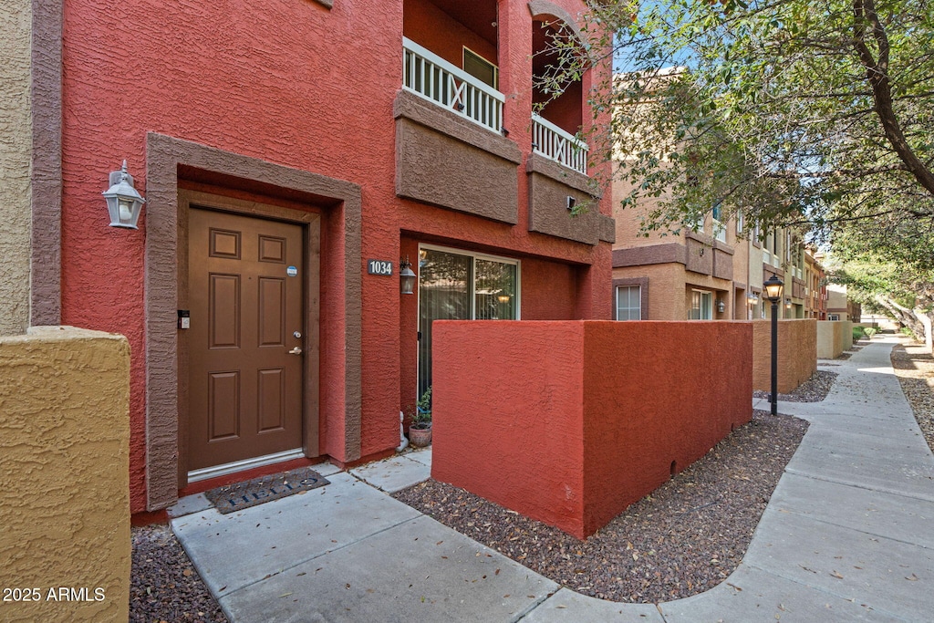 1920 E Bell Rd Unit 1034, Phoenix, AZ 85022 - view of exterior entry featuring a balcony and stucco siding