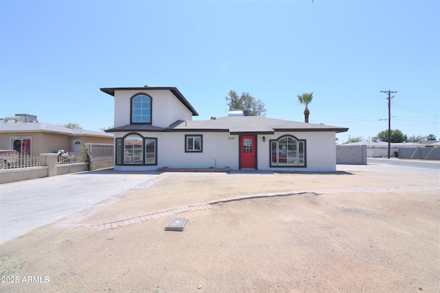 view of front of property with fence and stucco siding