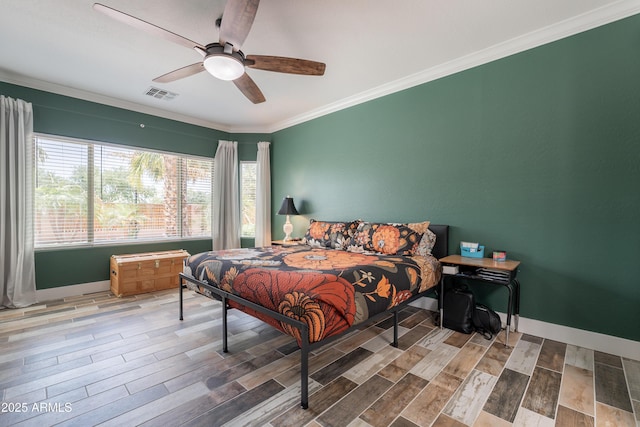 bedroom featuring crown molding, wood finished floors, baseboards, and ceiling fan