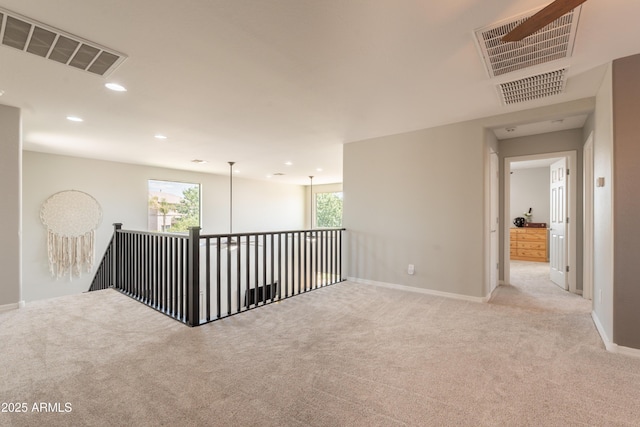 spare room with carpet, baseboards, and recessed lighting