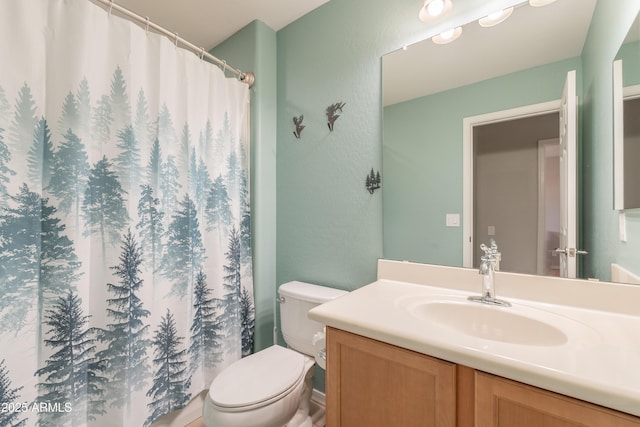 full bathroom featuring toilet, vanity, a shower with curtain, and a textured wall