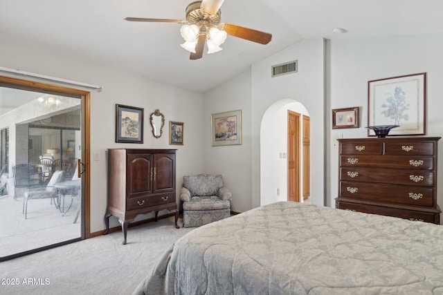 carpeted bedroom with access to exterior, arched walkways, vaulted ceiling, and ceiling fan