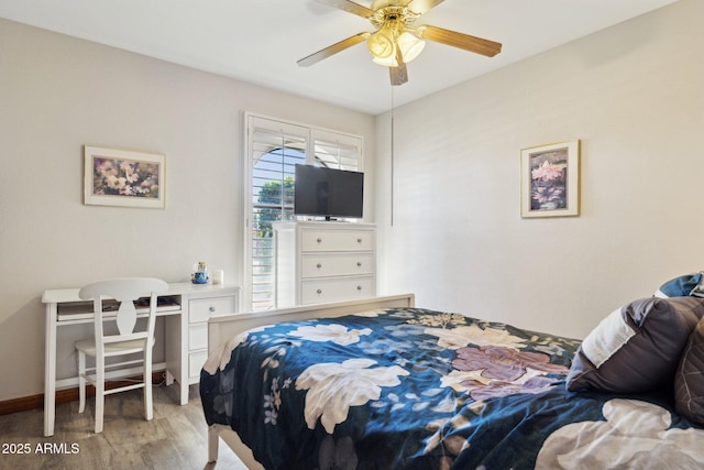 bedroom with wood finished floors, baseboards, and ceiling fan