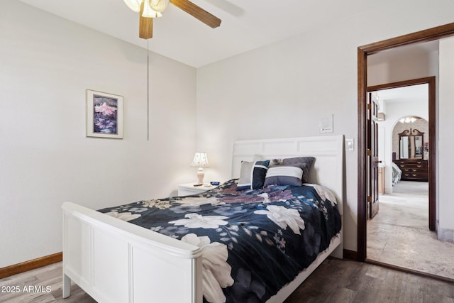 bedroom featuring wood finished floors, baseboards, and ceiling fan