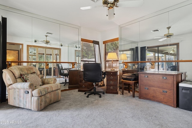 office featuring a ceiling fan, carpet, and healthy amount of natural light