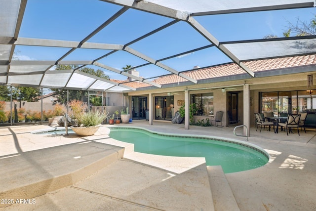 outdoor pool with a patio and glass enclosure