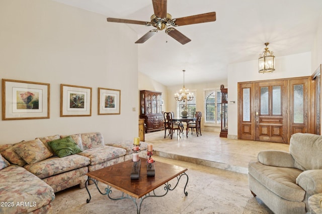 living room with a chandelier, a ceiling fan, and high vaulted ceiling