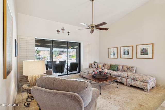 living area featuring a ceiling fan and high vaulted ceiling