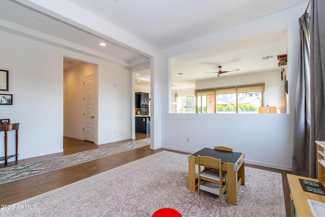 rec room with ceiling fan and wood-type flooring