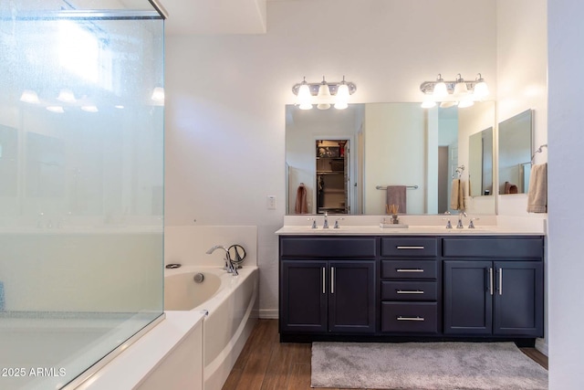 bathroom with a bathtub, hardwood / wood-style floors, and vanity