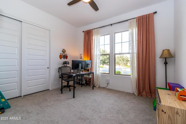 home office with light carpet and ceiling fan