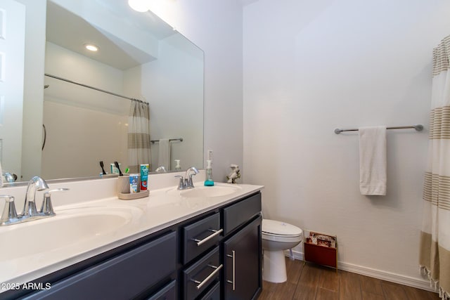 bathroom featuring vanity, toilet, and curtained shower