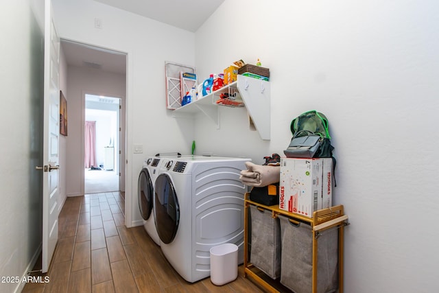 clothes washing area with washer and clothes dryer