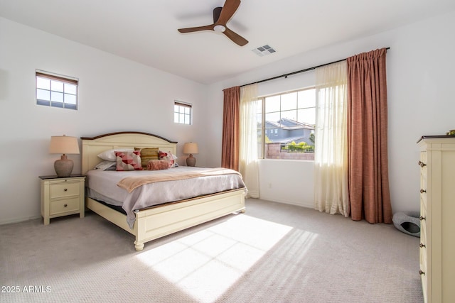 bedroom featuring ceiling fan and light carpet