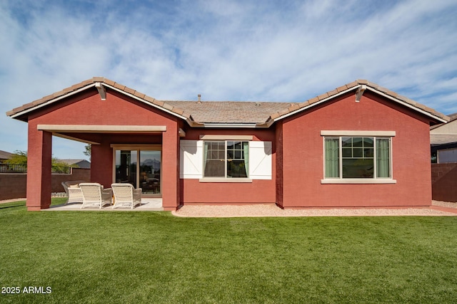 back of property featuring a patio area and a yard