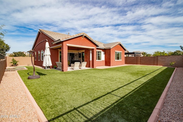 back of property featuring a lawn, an outdoor hangout area, and a patio