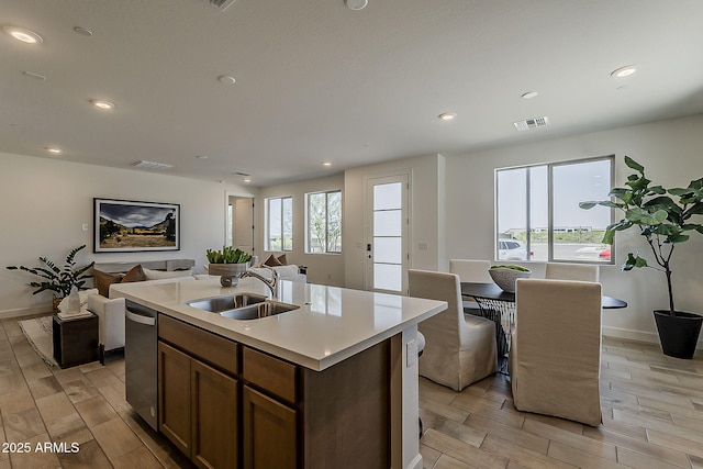 2121 W Sonoran Desert Dr Unit 86, Phoenix, AZ 85085 - kitchen with open floor plan, wood finish floors, light countertops, a kitchen island with sink, and recessed lighting