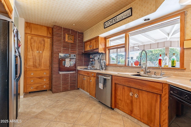 kitchen featuring light tile patterned flooring, sink, and stainless steel appliances