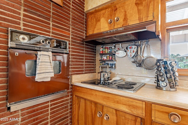 kitchen with wall oven and cooktop